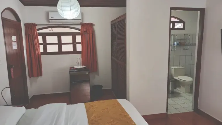 The room has a refrigerator and desk